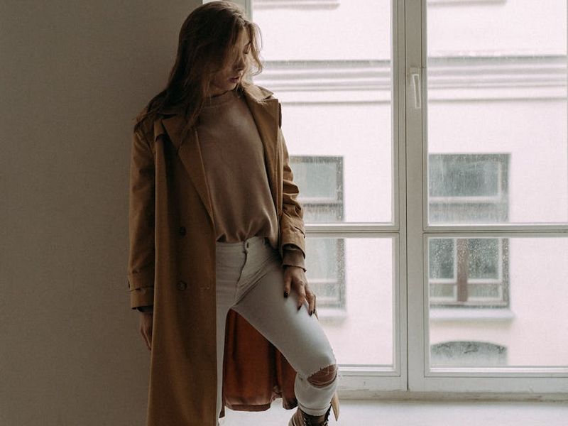 Person doing a tree pose in front of a window